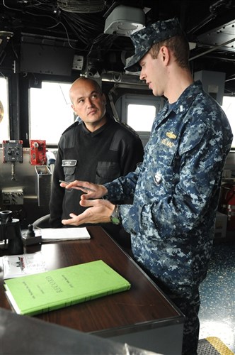 ISTANBUL, Turkey (Oct. 15, 2011) - Lt. j.g. Blake Tribou explains the responsibilities of the officer of the deck to Bulgarian navy Lt. Dimitar Haidutov, while embarked aboard USS Philippine Sea (CG 58). Two Bulgarian naval officers and two Bulgarian chief petty officers embarked the ship to observe how the U.S. Navy conducts operations underway. Philippine Sea is on a regularly scheduled deployment in the Black Sea and serves to promote peace and security in the U.S. 6th Fleet area of responsibility.