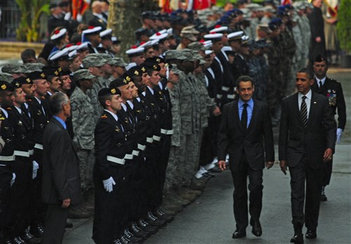 CANNES, France (Nov. 4, 2011) –President Barack Obama and French President Nicolas Sarkozy look over French and U.S. service members during a commemoration ceremony held at Cannes City Hall. During the ceremony, Obama and Sarkozy honored the French and U.S. service members who participated in Operations Odyssey Dawn and Unified Protector, supporting the international response to the unrest in Libya and the enforcement of United Nations Security Council Resolution 1973. 