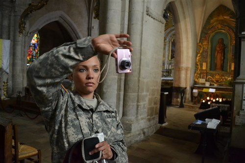 Sgt. Stephanie Cortez, 25, of Olympia, Wash., snaps a photo inside the church in Sainte-Mère-Eglise, France. 