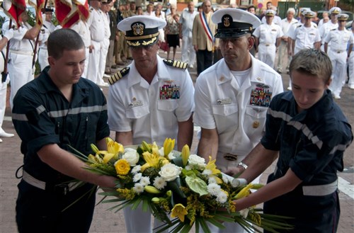 THEOULE-SUR-MER, France - Capt. Ted Williams, commanding officer of USS Mount Whitney (LCC 20), 2nd from left, and  Master Chief Jonathon Carter, Mount Whitney's command master chief, 2nd from right, lay a wreath in front of Theoule-sur-Mer's town hall during a ceremony celebrating the 68th anniversary of the Liberation of Provence by allied forces during World War II. Mount Whitney, homeported in Gaeta, Italy, is the U.S. 6th Fleet flagship and operates with a combined crew of U.S. Sailors and civil service mariners. The civil service mariners perform navigation, deck, engineering, laundry and galley service operations while military personnel aboard support communications, weapons systems and security. 