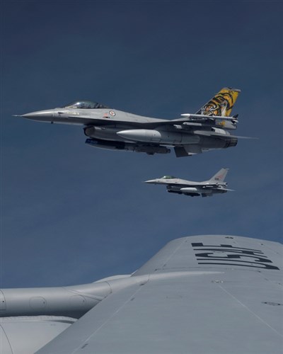 Two F-16 Fighting Falcons assigned to the Royal Norwegian Air Force fly alongside to the wing of a KC-135 Stratotanker assigned to RAF Mildenhall, England, while participating in the Baltic Region Training Event April 22, 2015, over the Baltic region. The BRTE is an advanced training concept that serves to further develop cooperation with NATO allies and partners within the region. (U.S. Air Force photo by Senior Airman Victoria H. Taylor/Released)