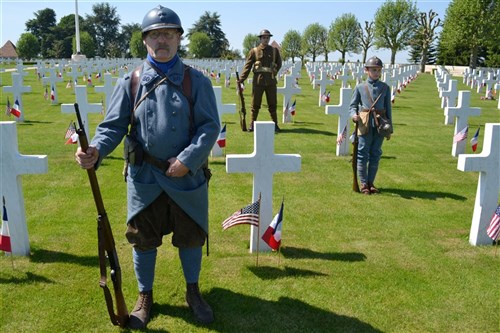 Several French history enthusiasts donned uniforms from both World War I and World War II. American Soldiers served in the Somme sector of the frontlines in France during World War I, alongside British, Canadian, Australian, Belgian and French forces. The Somme American Military Cemetery, near Bony, France, is the final resting place for more than 1,800 U.S. Soldiers. On May 27, 2012, troops from U.S. European Command, to include keynote speak Rear Admiral John Messerschmidt, U.S. Army Soldiers from the 5th Signal Theater Strategic Command and the Shape International Band, took part in a Memorial Day ceremony. 