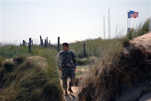 NORMANDY, France &mdash; Army Pfc. Scott Simpson, a medic with Headquarters and Headquarters Company, 173rd Airborne Brigade Combat Team, walks along Utah Beach here June 4. During the Normandy invasion 65 years ago Simpson&#39;s grandfather, Master Sgt. Joseph Simpson, landed on the beach with the 4th Infantry Division. (Department of Defense photo by Army Sgt. Fay Conroy)