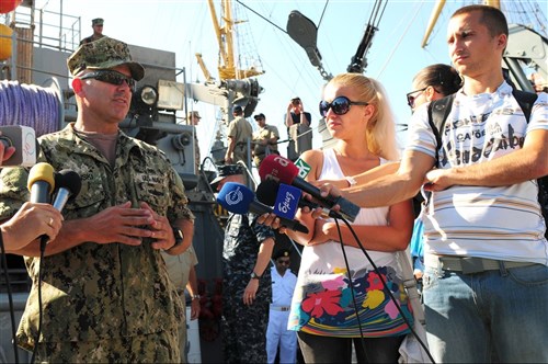 ODESSA, Ukraine - Chief Warrant Officer James Hordinski, officer in charge of Mobile Diving Salvage Unit 2, second from left, explains the properties of a divers helmet during a combined diving demonstration as part of Exercise Sea Breeze 2012 (SB12). SB12, co-hosted by the Ukrainian and U.S. navies, aims to improve maritime safety, security and stability engagements in the Black Sea by enhancing the capabilities of Partnership for Peace and Black Sea regional maritime security forces. 