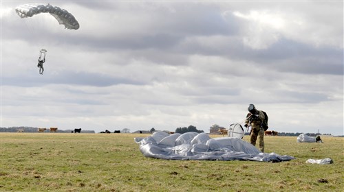 Pararescuemen from the 321st Special Tactics Squadron begin their 10,000-foot journey back to solid ground March 12, 2013, near Sculthorpe, England. The 321st STS conducted a week-long jump exercise to keep its members proficient in their ability to tactically insert into combat zones. In addition to their ability to conduct free-fall missions, pararescuemen are specially trained to conduct combat recovery operations in austere locations.