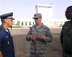 U.S. Air Force Maj. Michael Simons, African Partnership Flight Mauritania team lead, speaks with Tunisian Air Force Maj. Karim Boukara, instructor pilot, and Mali Air Force Maj. Soliba Yacouba Coulibaly, helicopter instructor pilot, before the start of the second day of APF Mauritania at Atar Airbase, Mauritania Sept. 1, 2014. A team of more than 50 students from six African nations are taking part of this APF with a combined goal to increase aviation capacity, enhance regional cooperation and increase interoperability. (U.S. Air Force photo/Master Sgt. Brian Boisvert)