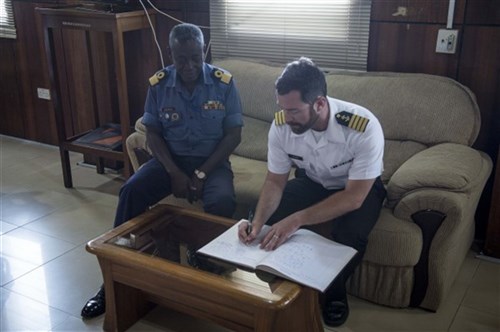 Capt. James Regan, ship’s master of the Military Sealift Command’s joint high-speed vessel USNS Spearhead (JHSV 1), right, signs the official guest registry of Commodore Steve Darbo of Ghanaian navy March 26, 2015. Spearhead is on a scheduled deployment to the U.S. 6th Fleet area of operations in support of the international collaborative capacity-building program Africa Partnership Station. (U.S. Navy photo by Mass Communication Specialist 2nd Class Kenan O’Connor/Released)