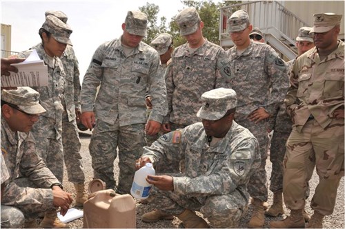 CAMP LEMONNIER, Djibouti (March 26, 2012) U.S. Army Staff Sgt. Andre Moxley, 490th Civil Affairs Battalion Functional Specialty Unit preventive medicine non-commissioned officer, demonstrates how to use bleach to re-chlorinate and disinfect a five-gallon water container here, March 26. The 490th CA BN FxSP taught field sanitation certification training here March 26-30. The course included instruction on proper field sanitation techniques for maintaining clean air, water and food supplies while in the field, as well as how to properly identify rodent and insect infestations and how to prevent them. (U.S. Air Force photo by Tech. Sgt. James Brock