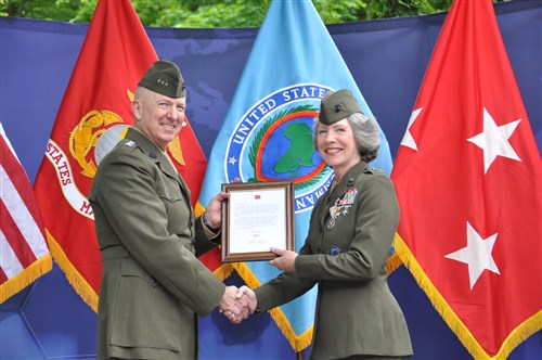 Lt. General Steven Hummer, Deputy Commander for Military Operations, U.S. Africa Command, presents the certificate of retirement to Maj. General Tracy Garrett during a retirement ceremony at the AFRICOM Headquarters, May 8, 2014. 