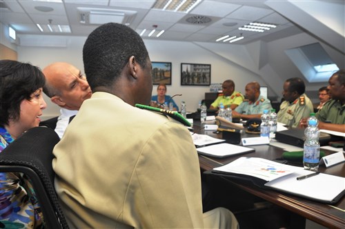 STUTTGART, Germany - During a U.S. Africa Command briefing,  June 22, 2012, delivered by Karen Hansis, AFRICOM J-5, two defense attache officers from Algeria and Niger listen as Christine Teska translates in French.  The briefing was presented to 11 African defense attaches who visited the command headquarters in Stuttgart, Germany, to gain knowledge about AFRICOM's programs and objectives.   The visit was described as a step to building long, lasting relationships with African defense attaches.  (U.S. AFRICOM photo by Staff Sergeant Olufemi A. Owolabi)      