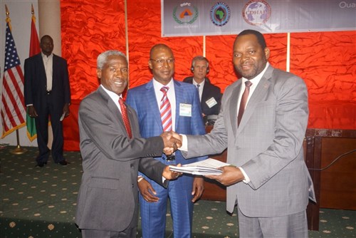 United States Ambassador to Burkina Faso, Dr. Tulinabo S. Mushingi (left), and the Director General of the Burkina Faso General Directorate of Civil Protection, COL Lazare YAGO (center) present Burkina Faso’s newly developed plans to Burkina Faso’s Minister of State, M. BONGNESSAN Arsène Yé (right), during the opening ceremony of the Burkina Faso Disaster Preparedness and Response Exercise in Ouagadougou, Burkina Faso, 14 July. The event represented a successful collaboration among international and interagency organizations, with the Government of Burkina Faso hosting an event sponsored by U.S. Africa Command and executed by the Center for Disaster and Humanitarian Assistance Medicine. (Photo by CDHAM)