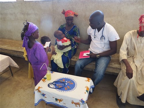 A local doctor consults with a patient/resident of Mini Village during a medical readiness training exercise (MEDRETE) conducted in Mini, Chad, Dec. 19, 2014. The exercise involved the Chadian medics working together with U.S. Special Operations Forces (USSOF) medics to obtain vital signs, perform initial consultations, present appropriate diagnoses, and prescribe proper medications and treatments for the people of Mini. (Courtesy photo)