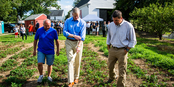 Governor Baker and Secretary Beaton inspecting strawberry crops.