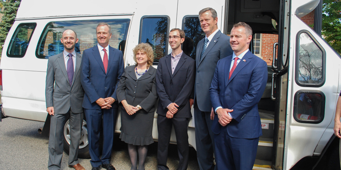 Governor Baker and others in front of a paratransit van.