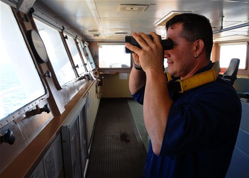 MEDITERRANEAN SEA (June 8, 2011)  Harvey Carvajal, an able-body seaman onboard maritime prepositioning ship USNS LCPL Roy M. Wheat, scans the horizon with binoculars on the ship's bridge during an at-sea training exercise for Phoenix Express 2011 (PE-11). A three-week exercise divided into in-port and underway training phases, PE-11 is designed to enhance regional maritime partnerships among the 13 participating countries in their efforts to deter illicit trafficking at sea. (U.S. Navy photo by Mass Communication Specialist 2nd Class (SW) Jeff Troutman)