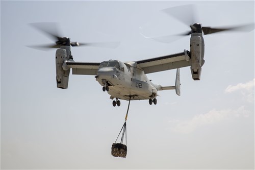 An MV-22 Osprey with Marine Medium Tiltrotor Squadron 263, Special Purpose Marine Air-Ground Task Force-Crisis Response-Africa, lifts a 1,098 pound pallet of Meals, Ready to Eat during a helicopter support team exercise aboard Naval Station Rota, Spain, July 6, 2016. External lifts allow pilots to deliver large cargo and supplies to Marines located in rough or unknown terrain without having to land the aircraft. (U.S. Marine Corps photo by Staff Sgt. Tia Nagle/Released)