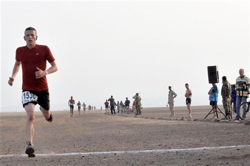 GRAND BARA DESERT, Djibouti - U.S. Army Staff Sergeant Nathan O&#39;Donnell crosses the finish line at the 28th Annual Grand Bara 15k Race, sponsored by the French Foreign Legion, December 16, 2010 in the Grand Bara Desert of Djibouti.  More than 300 members attached to Combined Joint Task Force - Horn of Africa and Camp Lemonnier participated in the race.  O&#39;Donnell was the first member of CJTF-HOA to finish the race. (U.S. Army photo by Specialist Sheri Carter)