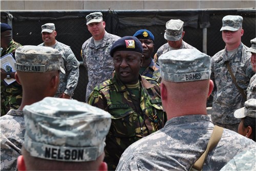 CAMP LEMONNIER, Djibouti (March 27, 2012) - Kenya Army Weapons Training Sgt. Major David Karisa Barisa (center) addresses Task Force Raptor soldiers, U.S. Army 3rd Squadron, 124th Cavalry Regiment, Texas Army National Guard, after completing a personnel inspection here March 27. Barisa, along with three other Kenyan Ministry of Defense senior enlisted leaders, visited their Combined Joint Task Force - Horn of Africa counterparts to exchange best practices and enhance understanding of the enlisted leadership roles and responsibilities that effect mission execution. (U.S. Navy photo by Mass Communication Senior Chief Petty Officer Maria R. Escamilla)