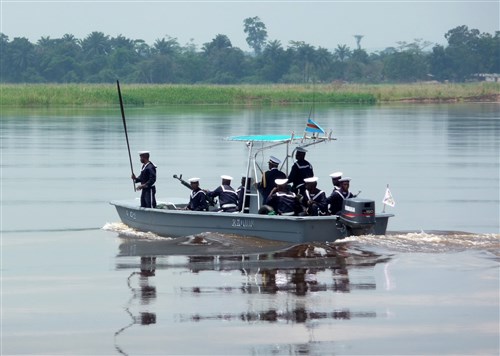 KINSHASA, Democratic Republic of the Congo - A Democratic Republic of Congo Navy boat accompanies Exercise Kwanza review participants on a cruise of the Congo River in October 2010. Economic Community of Central African States (ECCAS) held the exercise in order to validate Central African Multinational Force to African Union (AU) standards. The force is one of five brigade-size elements that make up the AU's Africa Standby Force--created to respond to crises on the African continent.  (U.S. Army photo by Major George K. Allen Jr.)