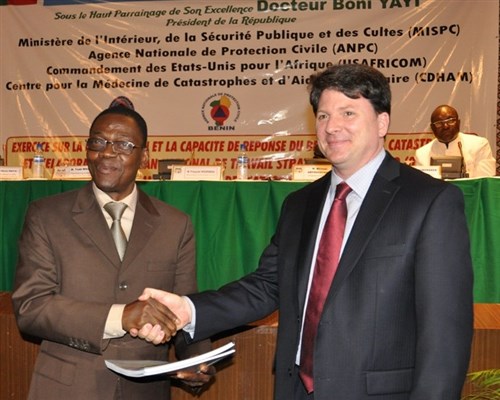 Francois Houessou, Benin Minister of Interior, and Todd Whatley, U.S. Deputy Chief of Mission to Benin, unveil the Pandemic Influenza Preparedness and Response Plan, and the Military Support to Civil Authorities (MSCA) Disaster Contingency Plan during a ceremony in Cotonou, Benin, on March 17, 2014.  The ceremony was followed by a five-day tabletop exercise to validate and identify the strengths, weaknesses and gaps in the plans and to develop a five-year Disaster Management Strategic Work Plan for the country. The event was sponsored by U.S. Africa Command (AFRICOM) and organized and executed by the U.S. Center for Disaster and Humanitarian Assistance Medicine (CDHAM). (U.S. Africa Command photo by Technical Sergeant Olufemi A. Owolabi/Released)