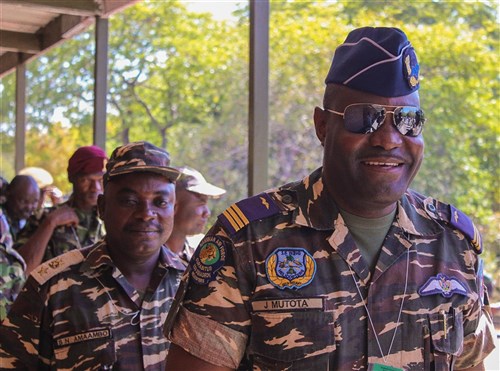 Officers from African partner nations enter the Malawi Armed Forces College Conference Center for the opening ceremony of Southern Accord 14, July 14. Southern Accord 14 will help provide participating military forces the skills required to enable readiness in support of peacekeeping and humanitarian support operations.