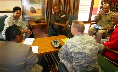 Air Force Captain Uzoamaka Odimegwu Mbakwem, International Health specialist, U.S. Africa Command (top, left), along with U.S. Army Lieutenant Colonel Justin Woodson, Associate Professor, Department of Military and Emergency Medicine Uniformed Services of the Health Sciences (USHS) (foreground, center) meet and discuss with Lieutenant General Sobantu Dlamini, Umbutfo Swaziland Defense Force (USDF) Commander (center), during a visit in Swaziland June 4, 2013.  Also present were Brigadier General Magagula, Operations Officer (top, right), Patrick Kunene, U.S President’s Emergency Program for AIDS Relief (PEPFAR) program manager (foreground, left), and Andrias Mathabelm, Principal Secretary, Ministry of National Defense and Security for Swaziland (foreground, right). (Photo U.S. Africa Command Public Affairs)