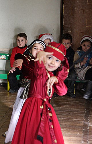 Kindergartners in Tbilisi, Georgia, performs Dec. 15 for visitors from European Command, USAID, U.S. Army Corps of Engineers, and the U.S. Embassy who visited to assess EUCOM&#39;s humanitarian assistance program in Georgia. The team, along with Rear Adm. Andy Brown, Director of Logistics at EUCOM, visited Kindergarten No. 215, one of four kindergartens for disabled children in the city.  EUCOM donated $10,000 in school supplies to the children. The team also visited the Georgian National Sports Federation for Children and Students, which supports the health and fitness of children, including those with disabilities, where they passed out medals and sports supplies to participants. (U.S. Army Corps of Engineers photo by Rachel Goodspeed)