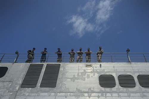 150406-N-RB579-019 PORT GENTIL, Gabon (April 6, 2015) Sailors stand on the flight deck of the Military Sealift Command’s joint high-speed vessel USNS Spearhead (JHSV 1) after the ship pulls into Port Gentil, Gabon April 6, 2015. Spearhead is on a scheduled deployment to the U.S. 6th Fleet area of operations in support of the international collaborative capacity-building program Africa Partnership Station. (U.S. Navy photo by Mass Communication Specialist 1st Class Joshua Davies/Released)