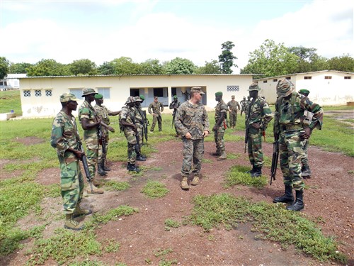 Cpl. Tyler Furman (center), an infantryman with Security Cooperation Team- 1, prepares members of the Senegalese Companie de Fusilier Marine Commandos, or COFUMACO, for a magazine reloading competition in Toubacouta, Senegal, Aug. 28, 2014. The competition was part of a joint-training engagement between U.S. Marines, Coast Guard, and the COFUMACO. (Courtesy Photo by Lance Cpl. Jonathan Neumann)