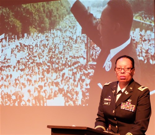 Lead planner and executor, U.S. Army Chief Warrant Officer Vickie Slade from U.S. Africa Command's legal office, narrates the program. “A Century of Black Life, History and Culture” served as the theme for this year’s Black History Month celebration, held at Kelley Barracks, U.S. Army Garrison Stuttgart, Feb. 26, 2015.  Performances by the Patch High School and Stuttgart Gospel Service Choirs and a dance from the play “Her Stories” highlighted the accomplishments of African Americans over the past century. (U.S. Africa Command photos by Brenda Law/Released)  