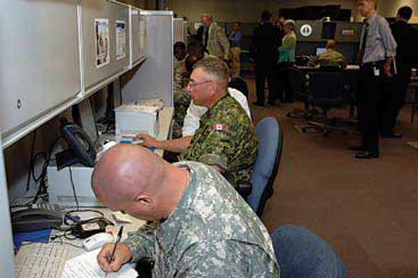 Soldiers from the United States and Canada test new technologies during the Coalition Warrior Interoperability Demonstration June 18. CWID provides a venue for military, state and local agencies as well as international partners to test technologies and procedures needed during inter-agency operations for disaster relief and humanitarian assistance. USNORTHCOM photo by Petty Officer 1st Class Joaquin Juatai.