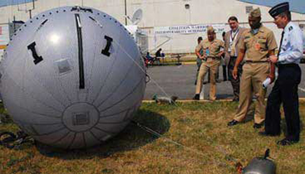 Defense Information Systems Agency Director Air Force Lt. Gen. Charles Croom (right) is briefed at Coalition Warrior Interoperability Demonstration (CWID) 2007 on the inflatable antenna capable of quick deployment and high-bandwidth communications in remote, hard-to-reach areas. Naval Surface Warfare Center, Dahlgren Division photo.