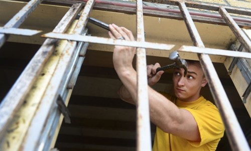 Information Systems Technician 3rd Class Austin Wills, originally from Tulsa, Oklahoma, and assigned to the USNS Spearhead (JHSV 1), helps refurbish the Centre Esperance Mission orphanage in Port Gentil, Gabon, April 8, 2015. Spearhead is on a scheduled deployment to the U.S. 6th Fleet area of operations in support of the international collaborative capacity-building program Africa Partnership Station. (U.S. Navy photo by Mass Communication Specialist 1st Class Joshua Davies/Released)