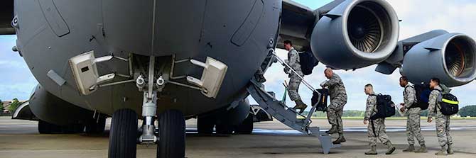 Service members boarding aircraft