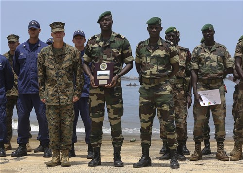 Second Lt. Aaron Burtner, security cooperation team leader, poses for a photo with Compagnie Fusilier de Marin Commandos after completing their final exercise with U.S. service members in Dakar, Senegal, September 17, 2015. The Marines and Coast Guardsmen with Special-Purpose Marine Air-Ground Task Force Crisis Response-Africa spent four weeks training the COFUMACO on basic infantry tactics and small-boat operations as a part of a Maritime Security Force Assistance mission to increase interoperability with Senegal’s and strengthen the bond between the partner nations.  (U.S. Marine Corps photo by Cpl. Olivia McDonald/Released)