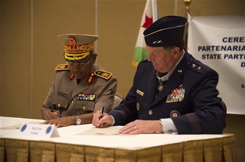 Maj. Gen. Zakaria Cheik Ibrahim, (left), Djiboutian Armed Forces (FAD) chief of defense and Maj. Gen. Edward Tonini, Kentucky National Guard (KNG) adjutant general, sign a State Partnership Program agreement at the Kempinski Hotel, Djibouti, June 2, 2015. The agreement means a long term cooperative agreement between the KNG and FAD that will foster mutually beneficial exchanges between the two at all levels of the military as well as the civilian world. (U.S. Air Force photo by Staff Sgt. Nathan Maysonet)