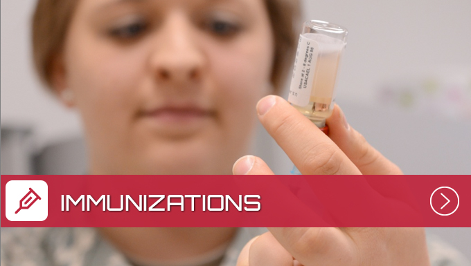 A nurse looking at a Immunization in a vial.