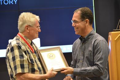 Jose Sanchez, director of Coastal and Hydraulics Laboratory, presents a service award to ERDC’s Dr. Lyn Hales, program manager for Monitoring Completed Navigation Projects, for 55 years of service to the nation Oct. 12. Hales was also presented with a Bronze de Fleury Medal from the Army Engineer Association for a lifetime of outstanding service and mentorship.