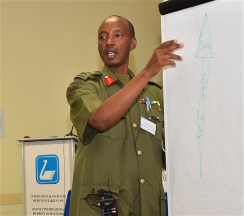 Former African Union Mission in Somalia (AMISOM) Commander, Maj. Gen. Fred Mugisha draws an African spear as an analogy to describe the challenge of executing peace operations where multiple systems of law are in use, and soldiers require the support of their command in confronting extraordinary logistical challenges."  Mugisha delivered the keynote address at the U.S. AFRICOM’s Fourth Africa Accountability Colloquium (ACIV) on “Responding to Gender Based Violence During Peace Operations.”  Nearly 40 military legal professional and commanders from 20 African countries have come together in an effort to lay the foundation for responding to sexual violence allegations that occur during peacekeeping operations.  The annual event is once again being hosted by the International Institute of Humanitarian Law (IIHL) in Sanremo, Italy, Mar. 1-3, 2016.  (U.S. Africa Command photo by Brenda Law/RELEASED)