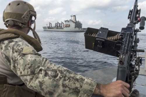 U.S. Navy Boatswain Mate 1st Class Anthony Al-Russan, Tactical Craft Crewman and Gunner, provides security watch from the bow of a Coastal Riverine Squadron One SeaArk 34-foot Dauntless patrol boat, while escorting USNS Laramie, Mar. 9. (U.S. Air Force photo Staff Sgt. Carlin Leslie)