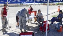 Two Airmen sign their individual medical paperwork at the Holloman drive-thru immunization clinic Oct. 4, 2016. The 49th Medical Group set up the drive-thru clinic to make it easier for active duty Holloman Airmen to obtain their annual flu shot. The 49th MDG staff administered the influenza vaccine to 720 Airmen. (U.S. Air Force photo by Airman 1st Class Alexis P. Docherty)