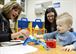 Ms. Suzanne Stinson, 59 MDW Speech-Language Pathologist, performs play therapy with her pediatric patient and his mother.  Play therapy is used to elicit conversation or repeat sounds in words for speech/language development. (Courtesy Photo)
