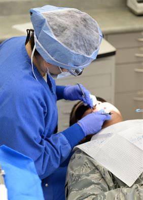 Capt. (Dr.) Nicole Catarino, 36th Medical Operations Squadron general dentist, performs a periodontal evaluation May 11, 2015, at Andersen Air Force Base, Guam. In addition to working on patient’s mouths, the dental flight also provides tips to Airmen to prevent additional visits to the dentists. (U.S. Air Force photo by Airman 1st Class Joshua Smoot/Released)