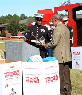 Gunnery Sgt. Jimmie Smith, coordinator, Toys for Tots, thanks and presents retired Marine Maj. James R. Edwards, Albany Salvation Army board member, with a plaque for participating in the Toys for Tots program. 