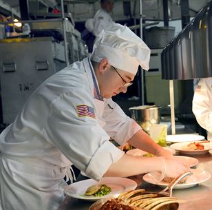 U.S. Marine Sgt. Joseph Hale arranges a dinner plate for the Pentagon team during the 2014 Military Arts Competition at Fort Lee, Va. March 11, 2014. (DoD photo by EJ Hersom)