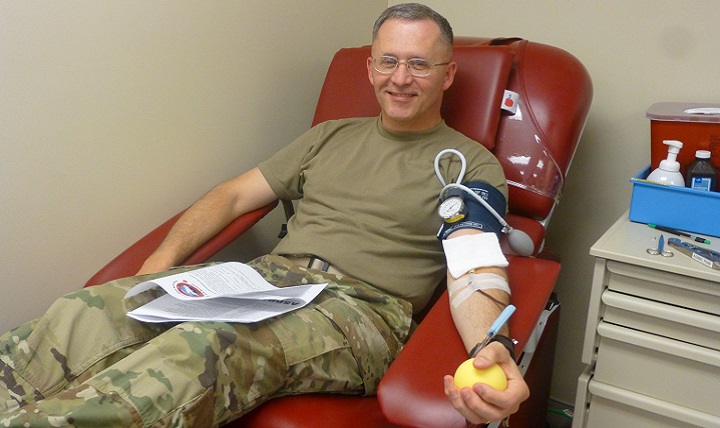 Army Col. Michael Place, commanding officer of the Madigan Army Medical Center at Joint Base Lewis-McChord, Washington, donated blood with the Armed Services Blood Bank Center-Pacific Northwest. (U.S. Army photo)