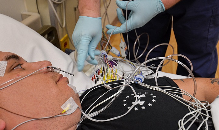 U.S. Army Sgt. 1st Class Bobby M. Scharton, a platoon sergeant with 17th Fires Brigade, 7th Infantry Division, lies down as Christopher Taylor, a sleep technician with Madigan Army Medical Center, checks sensor connections during a sleep study at Joint Base Lewis-McChord, Wash. Sleep technicians connect 26 sensors to patients that measure eye and muscle movements, brain activity, heart rate and breathing. (U.S. Army photo)