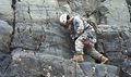 Can you train in the heat to improve your performance at altitude? The answer is “sort of.” A student in the Basic Military Mountaineering Course (BMMC) checks his harness during his test. 