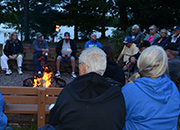 Veterans sitting around a camp fire.