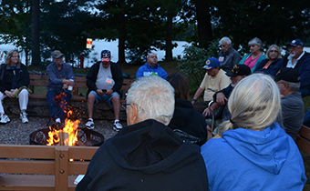 Veterans sitting around camp fire